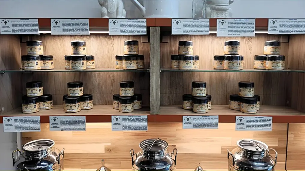Jars of honey on wooden shelves