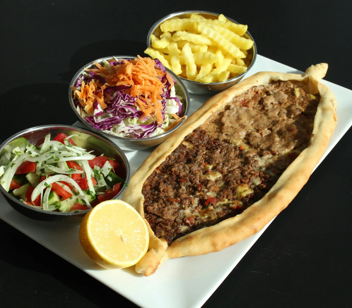 Meat pide platter with lemon and sides